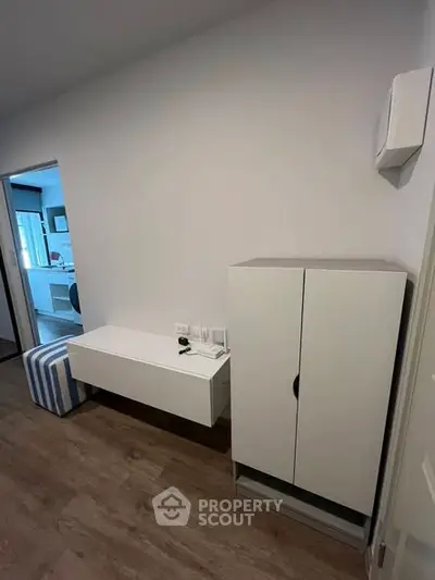 Modern interior with sleek white furniture and wooden flooring