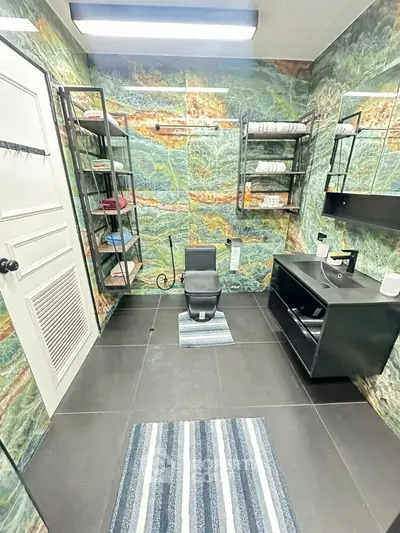 Luxurious bathroom with unique marble walls and modern fixtures