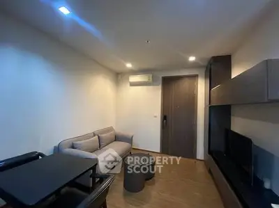 Modern living room with sleek furniture and ambient lighting in a contemporary apartment.