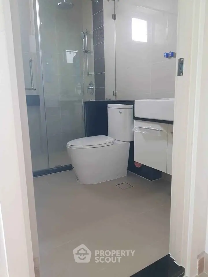 Modern bathroom with glass shower and sleek fixtures