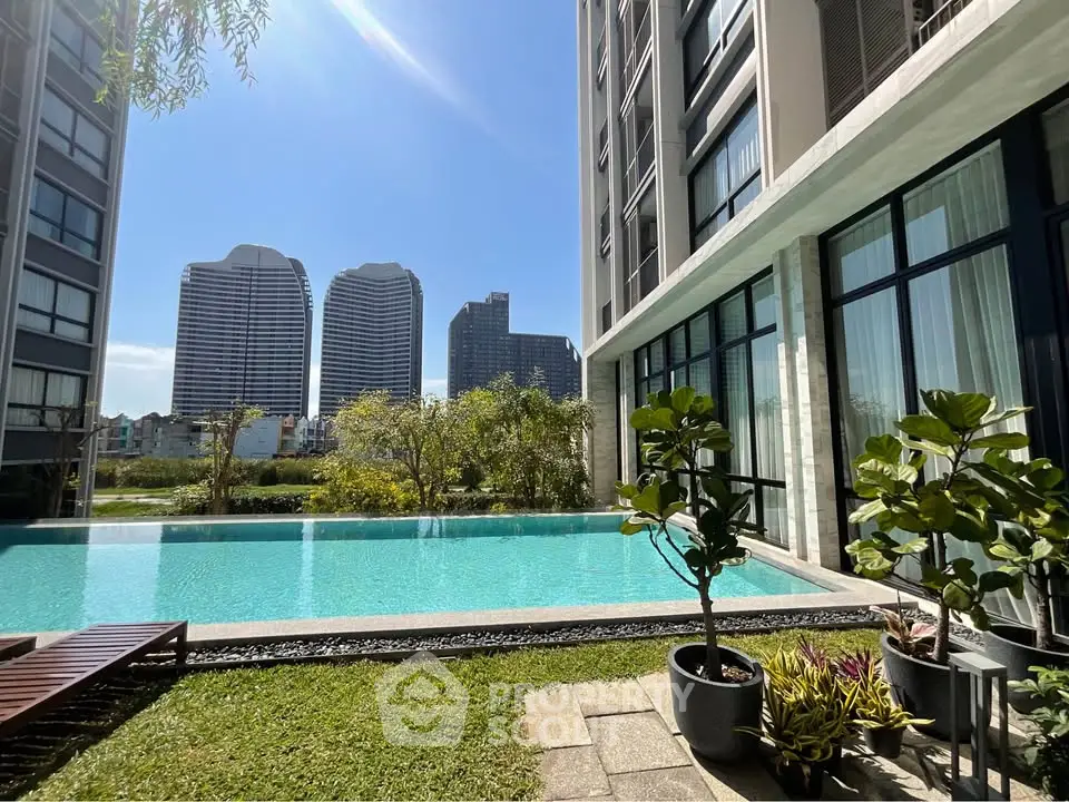 Luxurious apartment complex with stunning pool and city skyline view