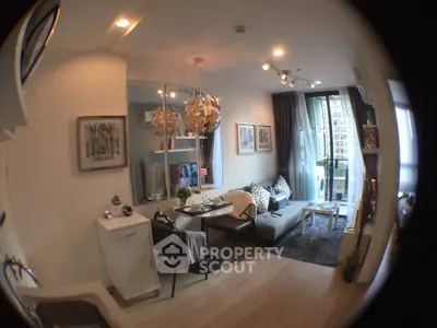 Modern living room with stylish decor and balcony view in a contemporary apartment.