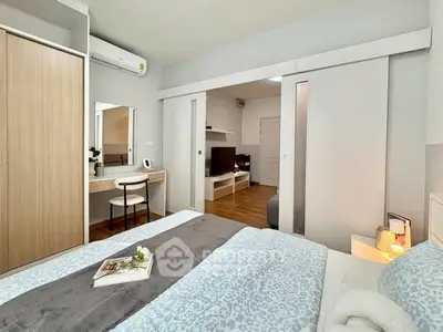 Modern bedroom with stylish decor and built-in wardrobe in a cozy apartment.