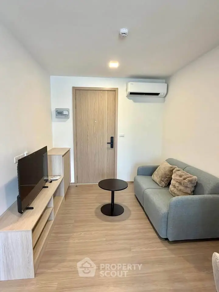 Modern living room with sleek furniture and air conditioning in a cozy apartment.