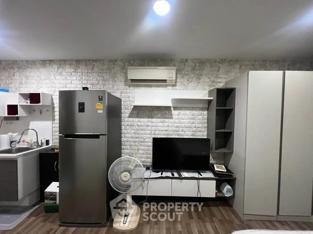 Modern studio apartment with sleek kitchen and cozy living area