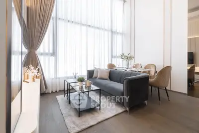 Modern living room with elegant decor and large windows