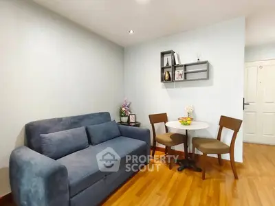 Cozy living room with blue sofa and dining set, perfect for modern living.