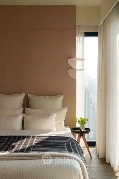 Elegant bedroom with city view, featuring modern decor and natural light.