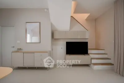 Modern minimalist living room with stylish staircase and sleek furniture