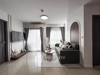 Modern living room with sleek design, large windows, and stylish furniture in a contemporary apartment.