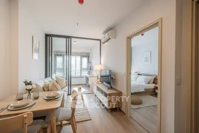 Modern open-plan living room and dining area with natural light and stylish decor