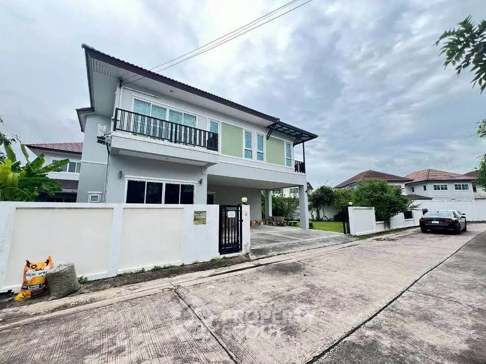 Modern two-story house with driveway and lush surroundings in a serene neighborhood.