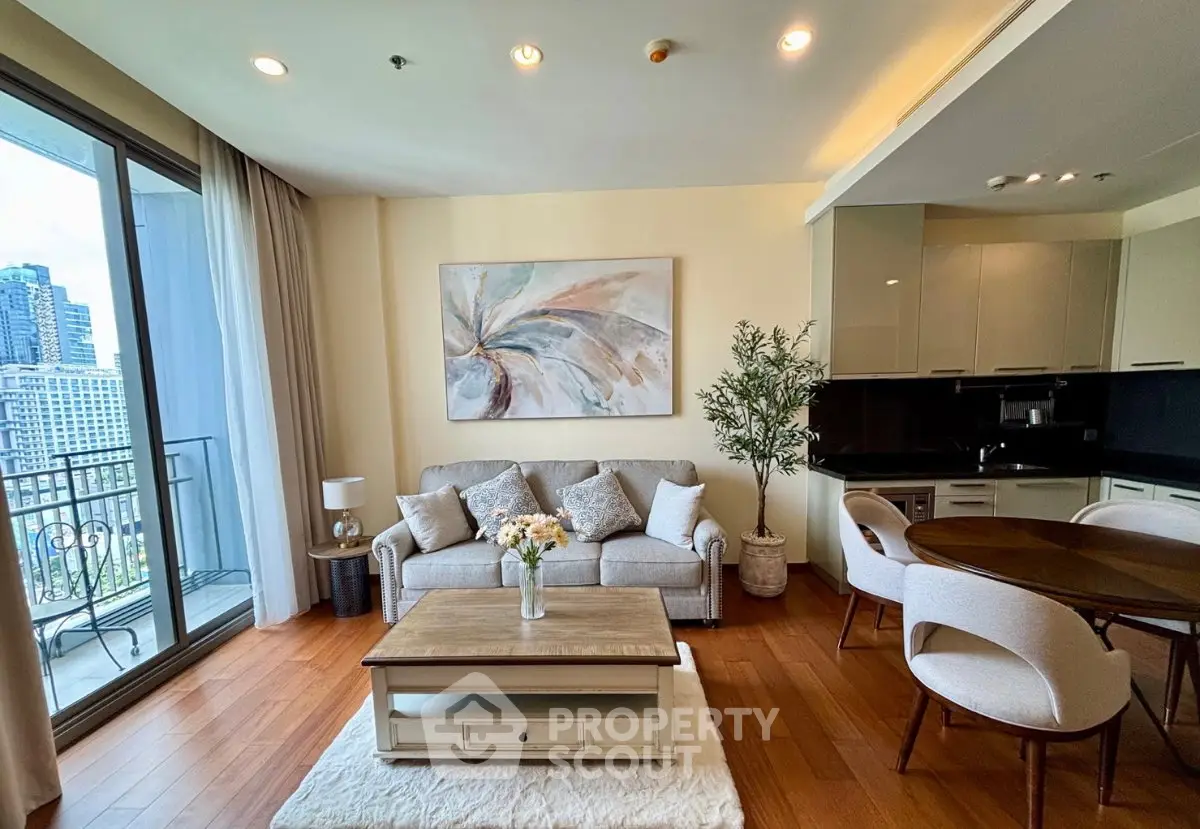 Elegant living room with modern decor, open kitchen, and city view balcony in luxury apartment.