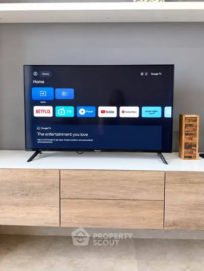 Modern living room with sleek TV unit and stylish wooden cabinet