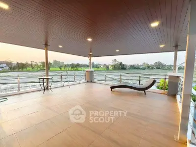 Spacious balcony with stunning countryside view, perfect for relaxation and outdoor gatherings.
