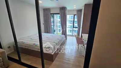 Modern bedroom with large windows and stylish decor in a high-rise apartment.