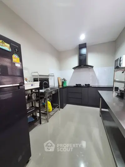 Modern kitchen with sleek black appliances and open layout