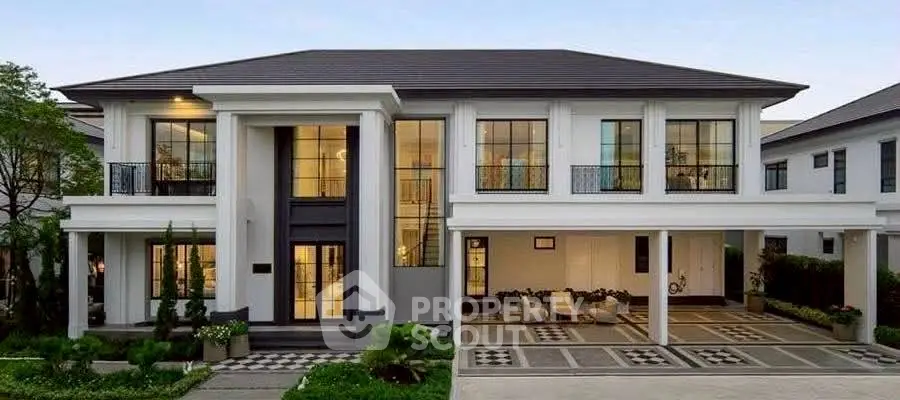 Luxurious modern mansion with grand entrance and elegant landscaping.