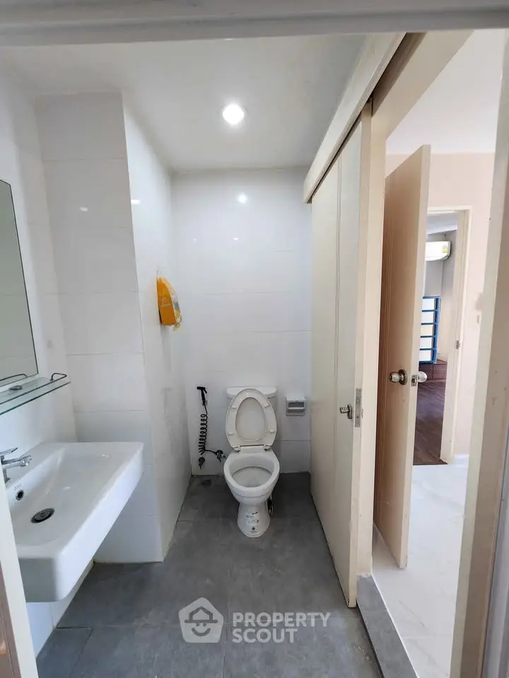 Modern bathroom with sleek fixtures and sliding door design