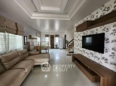 Spacious living room with modern decor and wall-mounted TV