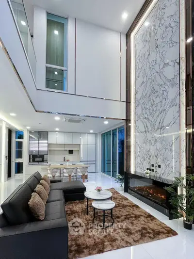 Luxurious modern living room with high ceiling and elegant marble fireplace