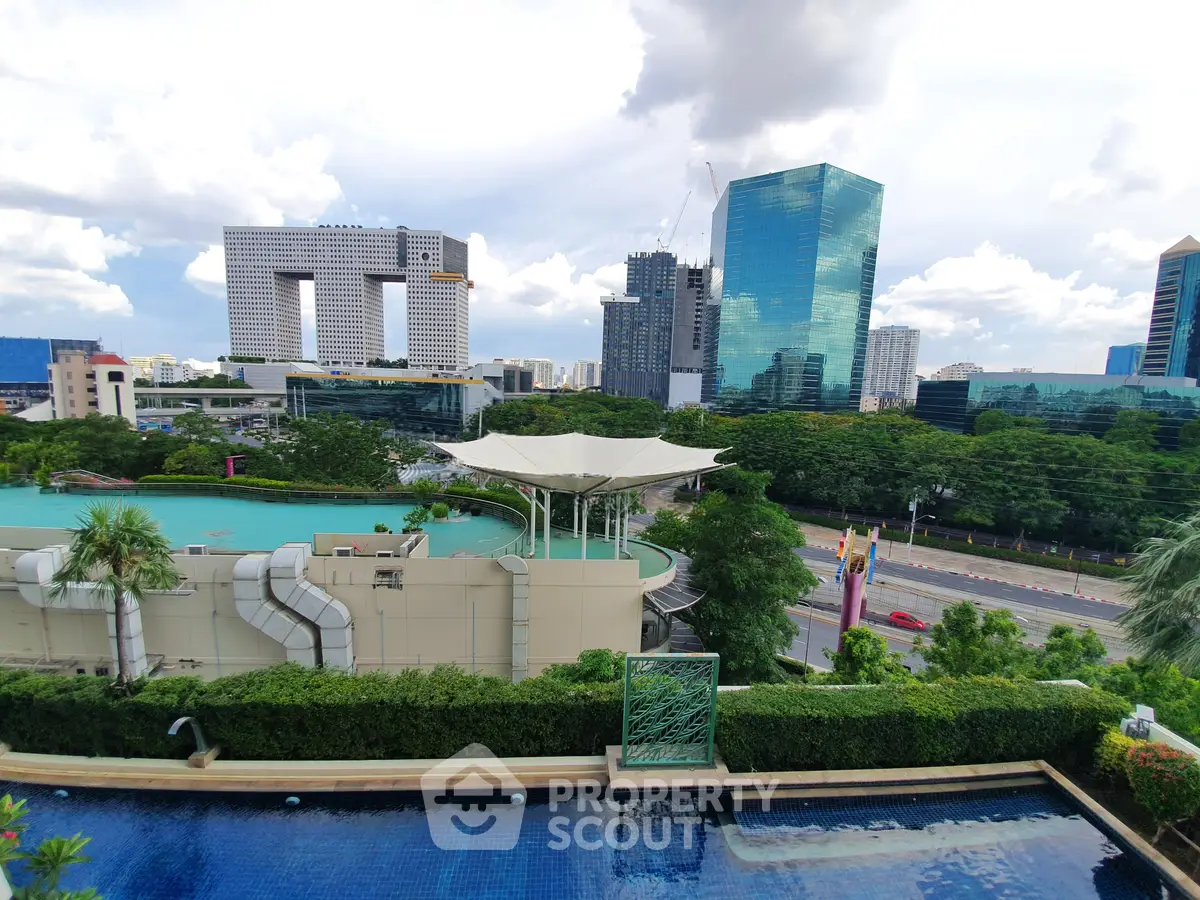 Stunning cityscape view with modern architecture and rooftop pool, perfect for urban living enthusiasts.