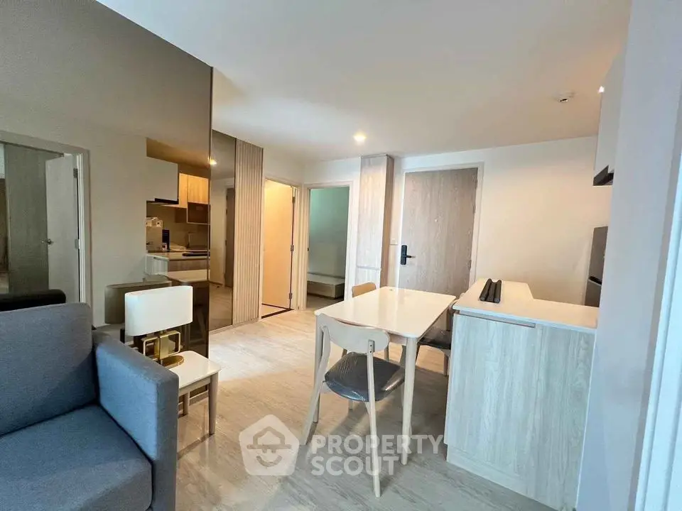 Modern open-plan living and dining area with sleek furniture and neutral tones.