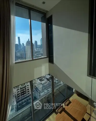 Stunning high-rise apartment with floor-to-ceiling windows and breathtaking city view.