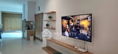 Modern living room with wall-mounted TV and sleek decor