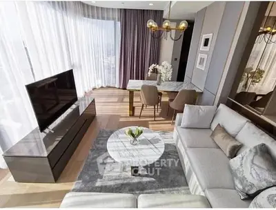 Luxurious modern living room with elegant decor and large windows offering ample natural light.