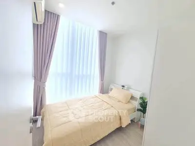 Bright and cozy bedroom with large window and modern decor