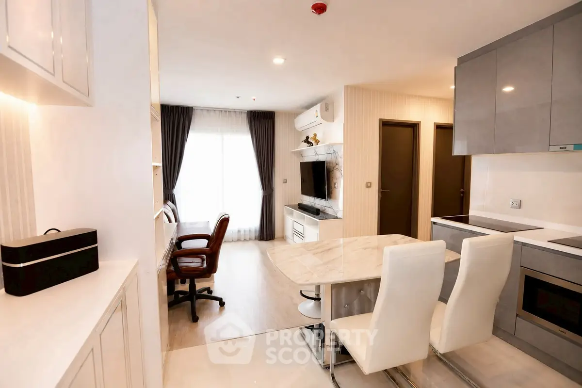 Modern open-plan living room and kitchen with stylish furniture and natural light.