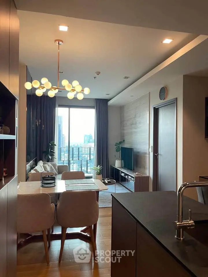 Modern living room with elegant lighting and city view, featuring stylish furniture and open layout.