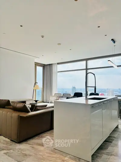 Luxurious open-plan living room with stunning city view and modern kitchen island.