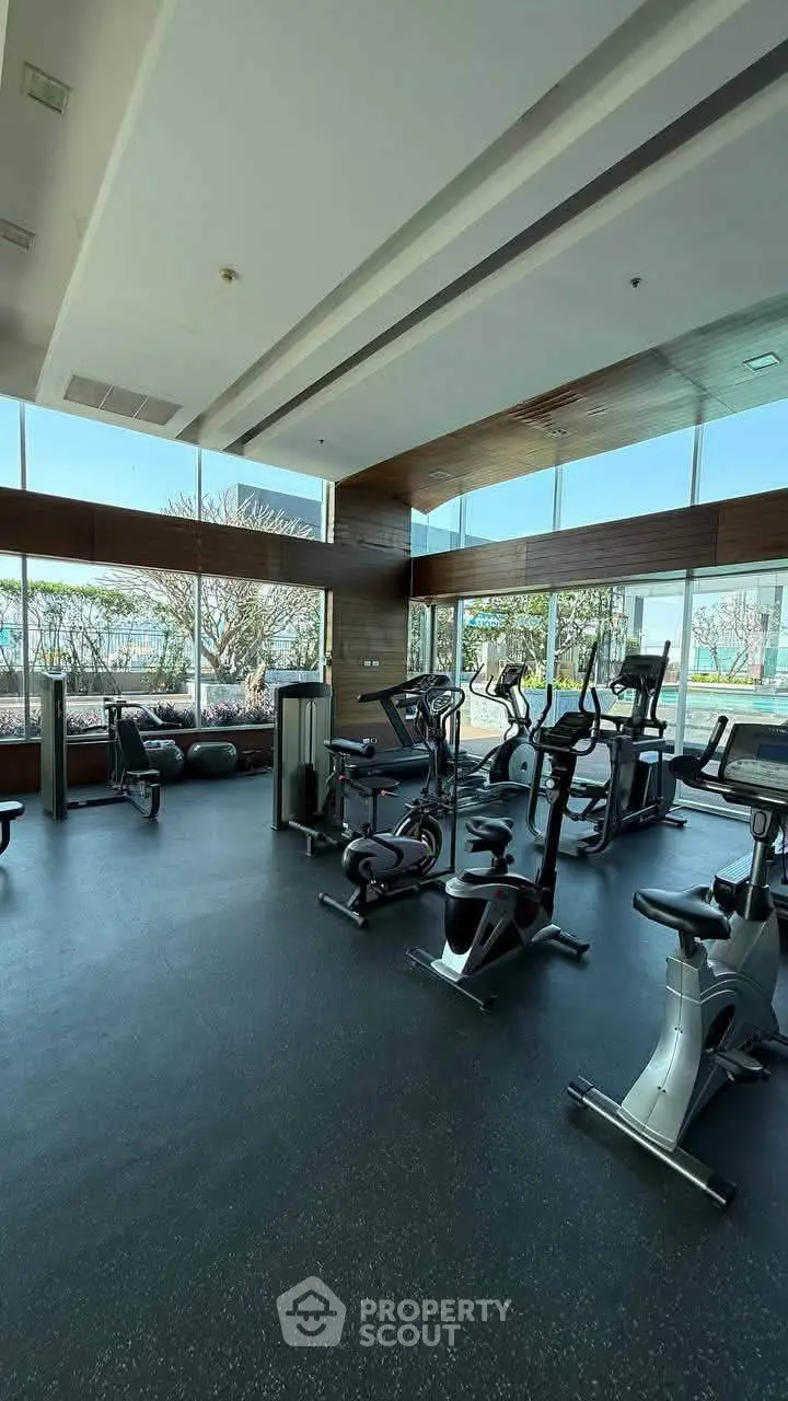 Modern gym with exercise bikes and large windows offering a scenic view, perfect for fitness enthusiasts.