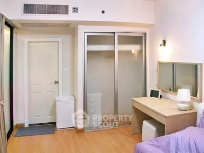 Cozy bedroom with sliding closet doors and a modern vanity desk