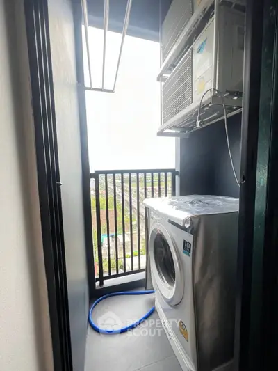 Compact balcony with washing machine and air conditioning unit, offering a practical utility space.