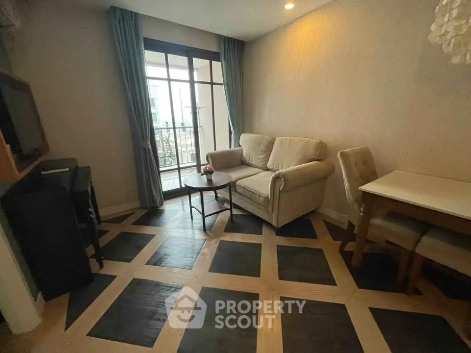 Charming living room with stylish parquet flooring and cozy seating area, perfect for relaxation.