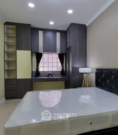 Spacious bedroom with modern built-in wardrobe and cozy lighting