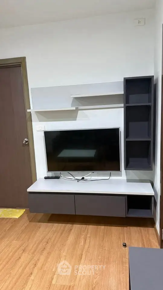 Modern living room with sleek TV unit and wooden flooring