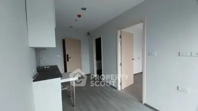 Modern minimalist apartment interior with compact kitchen and open layout