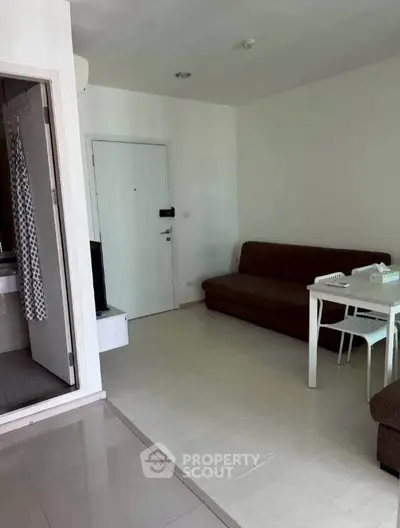 Cozy living room with modern sofa and dining table in a compact apartment