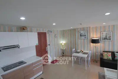 Charming open-layout kitchen and living area with modern decor and cozy dining space.