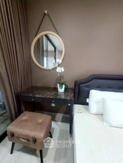 Stylish bedroom with elegant decor and cozy ambiance, featuring a chic vanity and plush bedding.