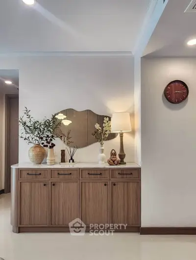 Elegant interior with stylish wooden cabinet and decorative elements, perfect for modern living spaces.