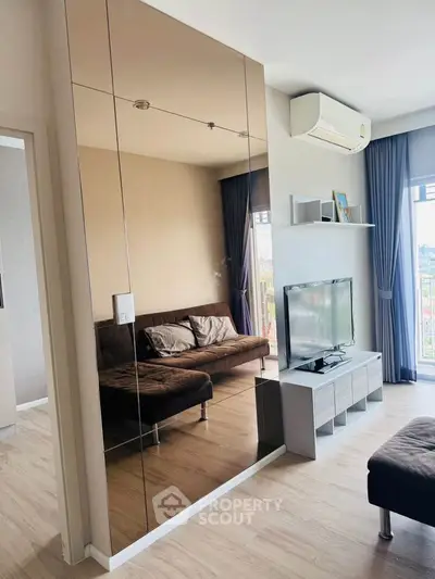 Modern living room with stylish decor and large mirror wall