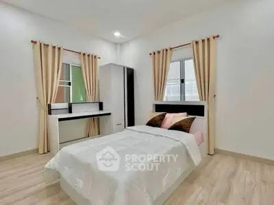 Modern bedroom with minimalist design, featuring a cozy bed, stylish curtains, and sleek furniture.
