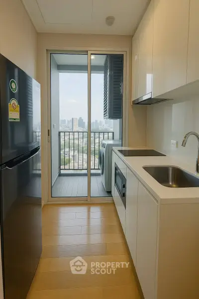Modern kitchen with sleek design and city view balcony
