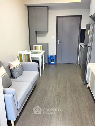 Modern apartment interior with cozy living area and compact kitchen