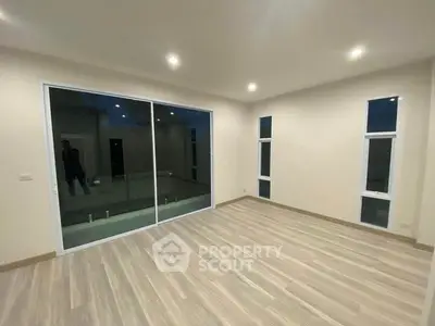 Spacious modern living room with large windows and sleek flooring